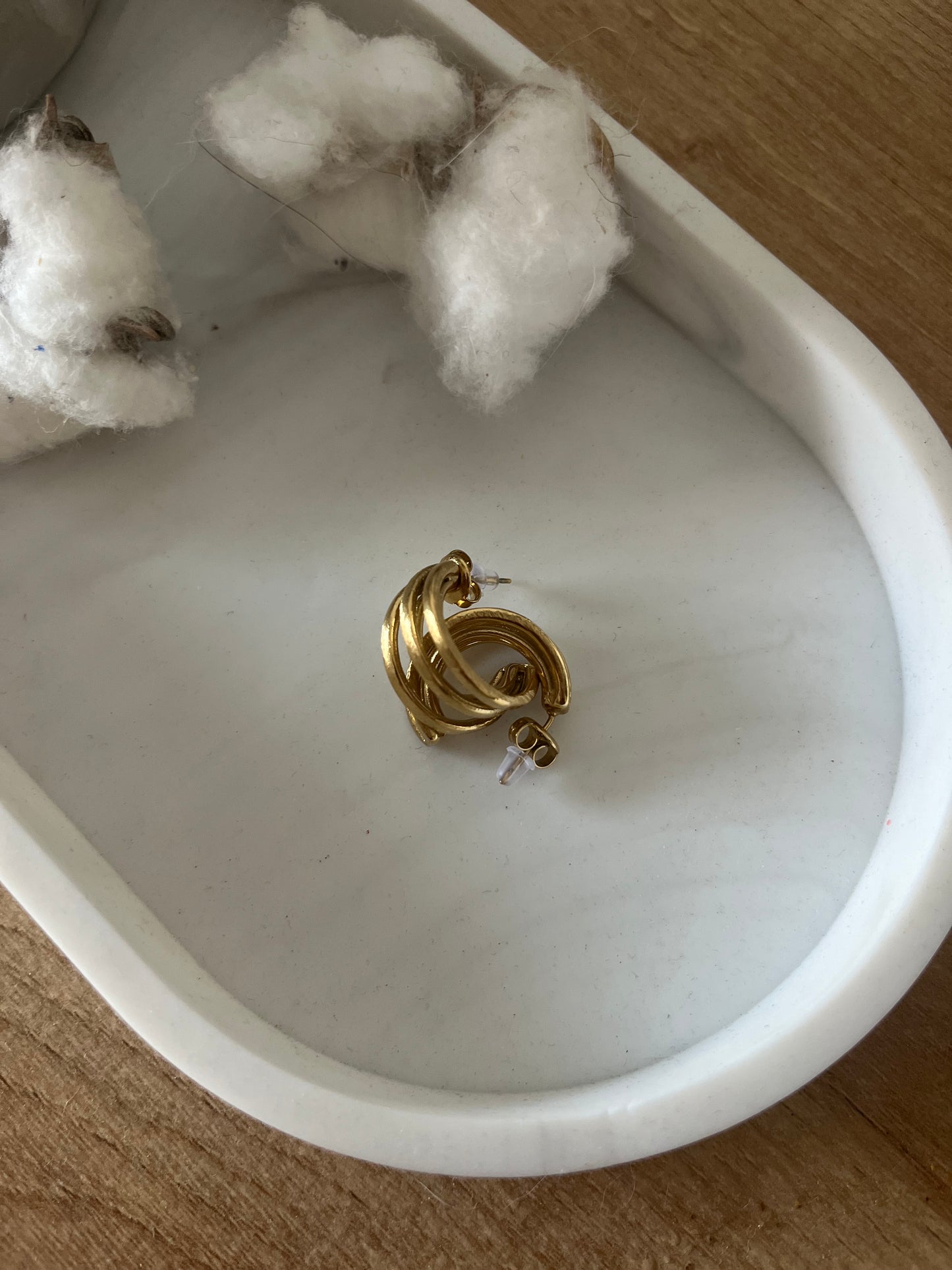 Boucles d'oreilles type créoles en acier inoxydable composées de plusieurs anneaux entrecroisés à l'effet brossé mat.