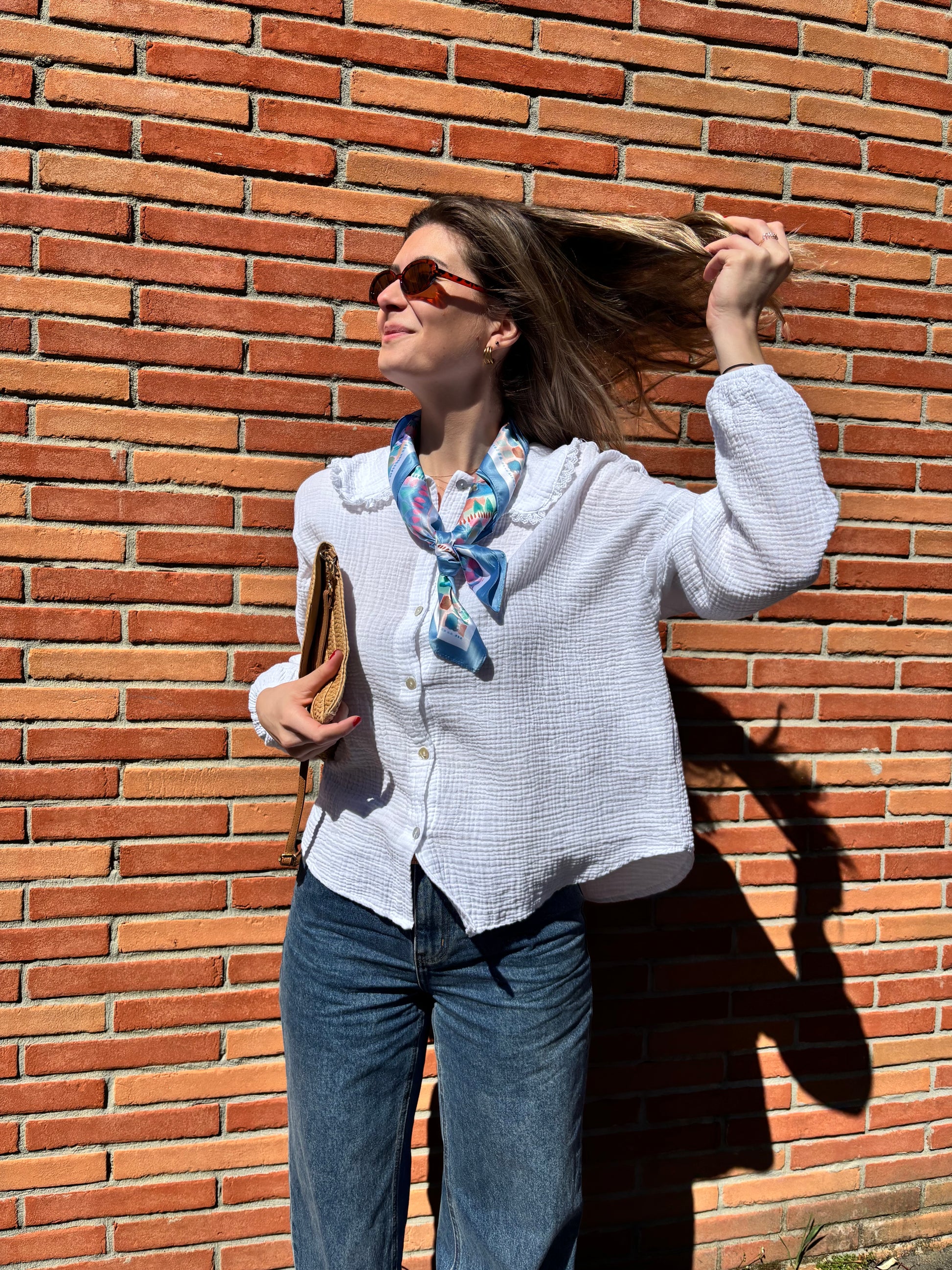 Foulard bleu pour femme orné de motifs élégants, accessoire tendance qui apporte une touche de style et de modernité à toutes vos tenues.
