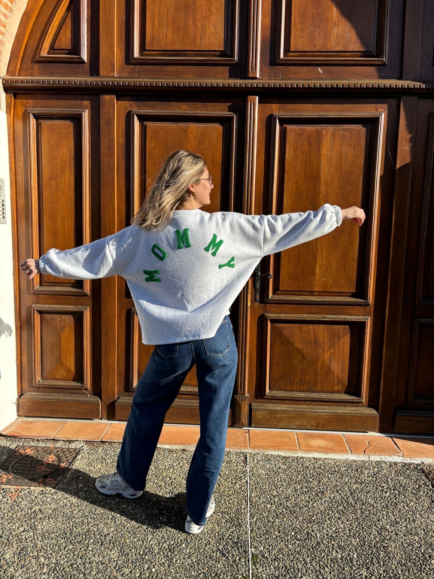 Pull tendance de couleur gris pour femme avec écriture mommy en vert dans le dos 