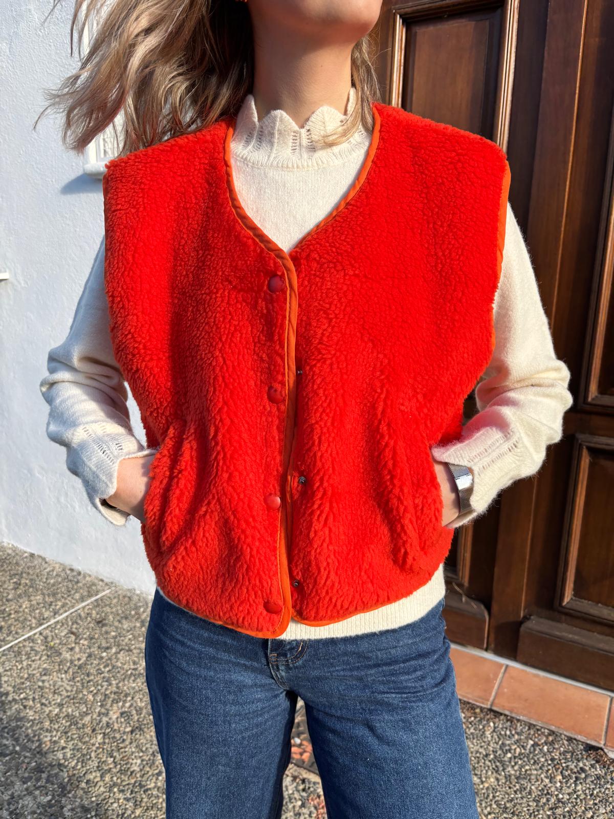Veste de couleur orange fluo pour femme avec bouton sur le devant et poche sur le côté